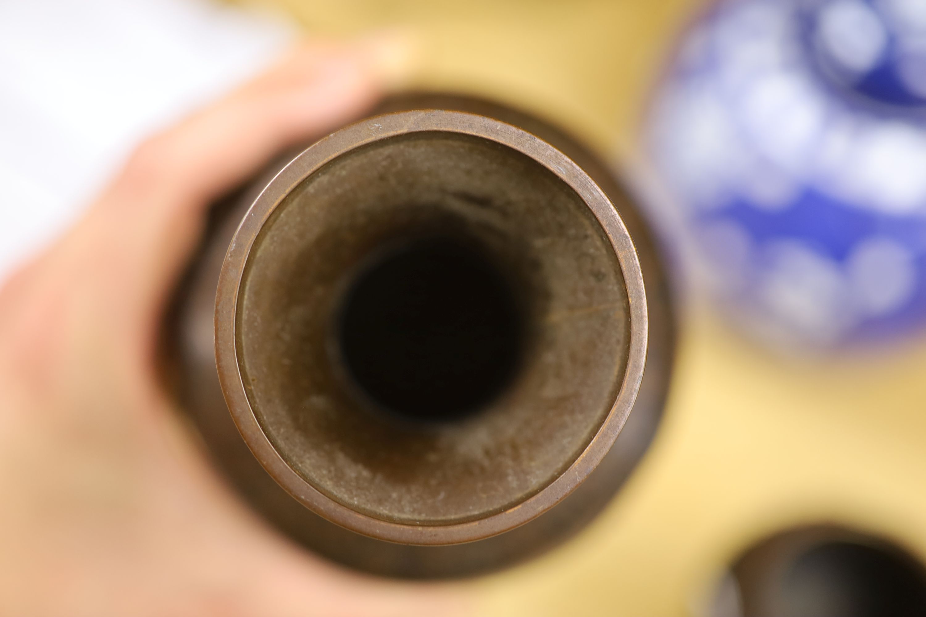 A Chinese blue and white cylindrical vase, another vase and cover and a blue and white jar and cover, together with a cloisonne vase and a bronze censer, tallest 32cm